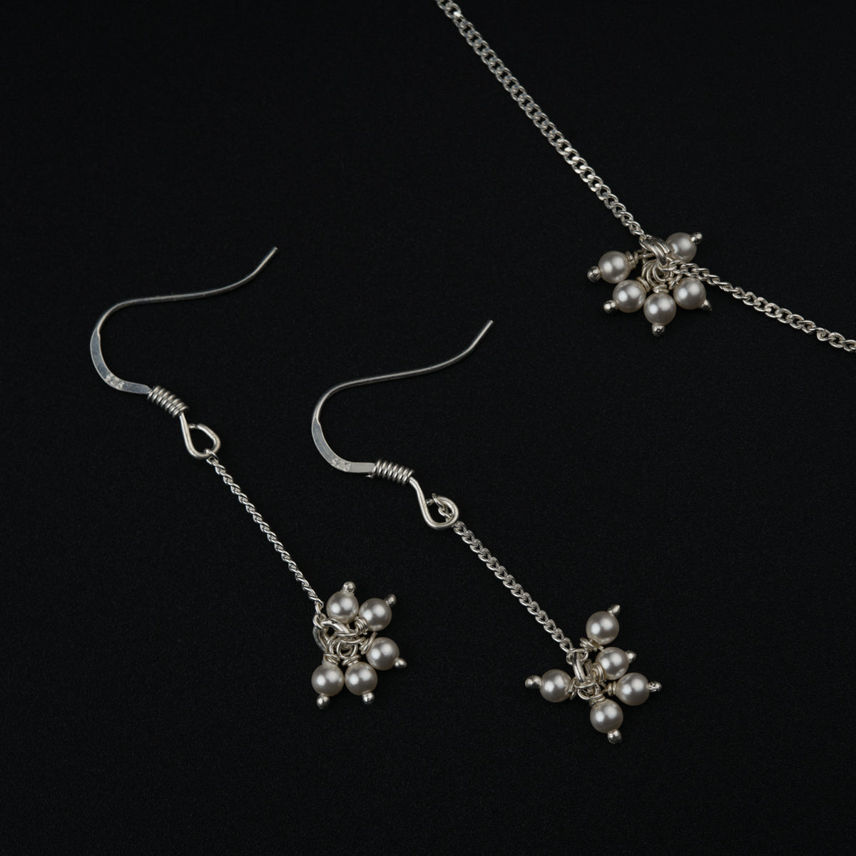 a close up of a pair of earrings on a black background