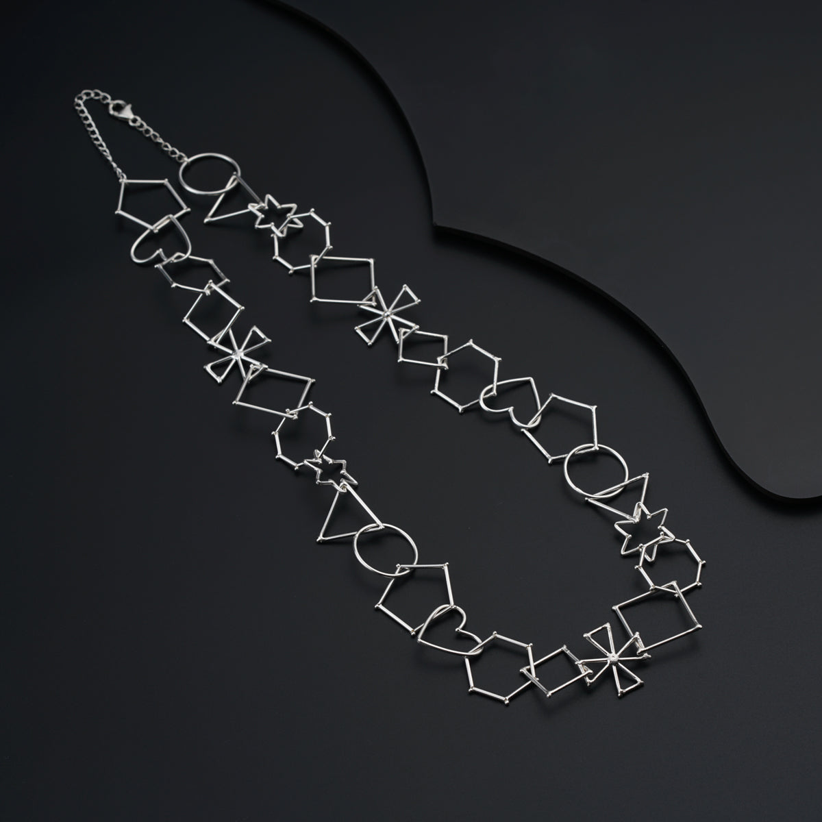 a necklace is shown on a black surface