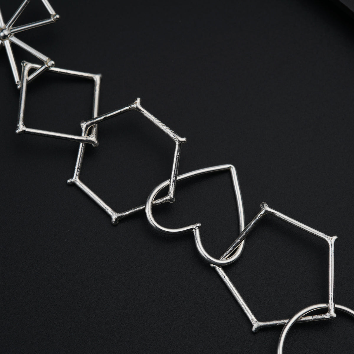 a close up of a metal object on a black surface