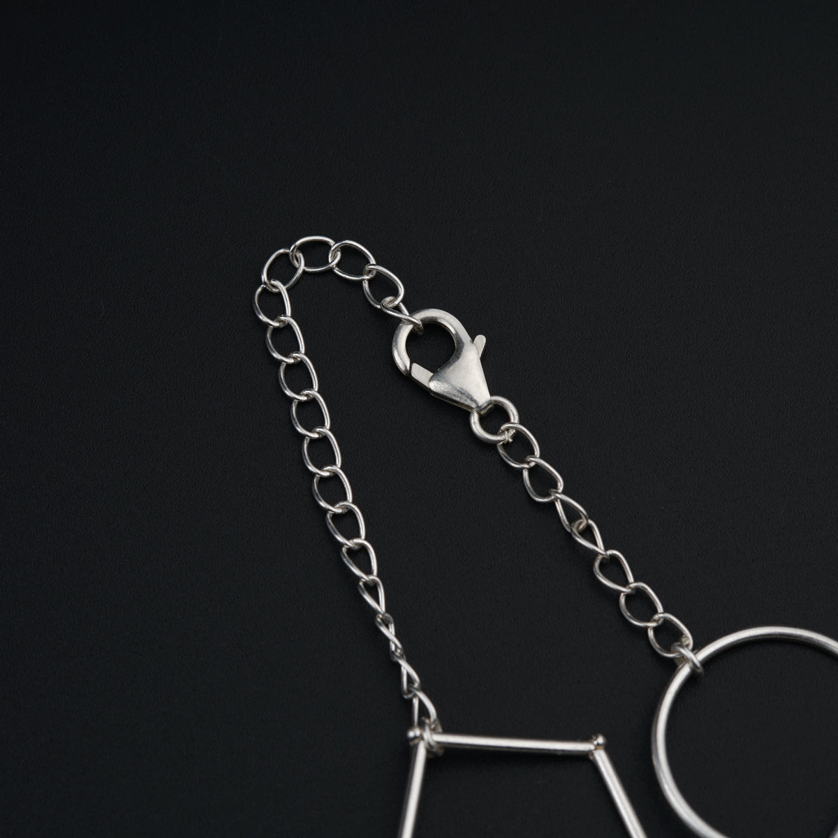a pair of scissors and a chain on a black surface