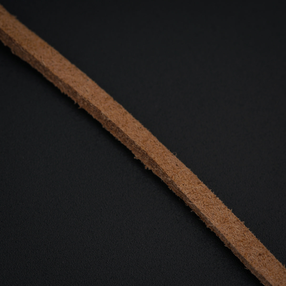 a close up of a piece of cardboard on a black surface