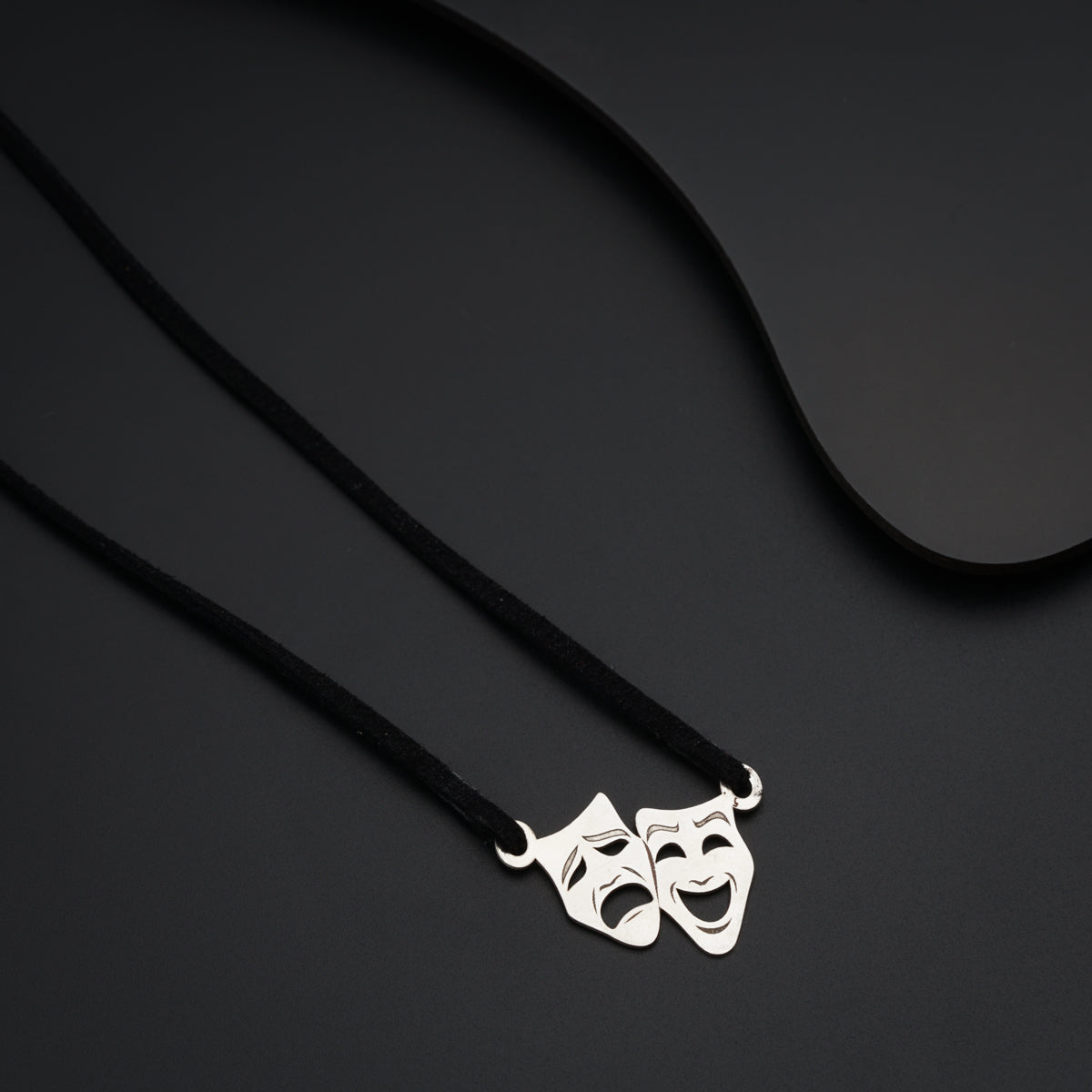 a couple of masks on a black cord