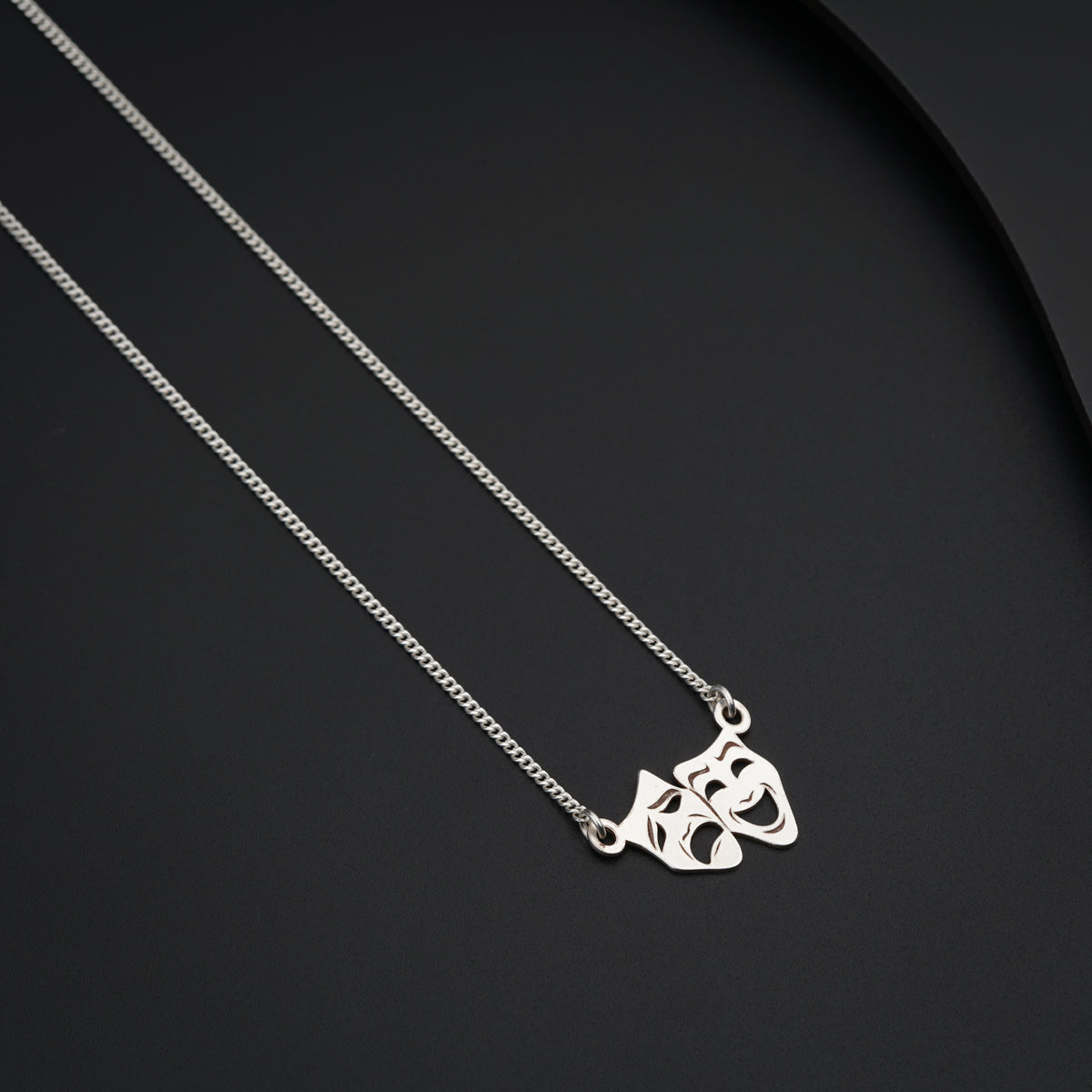 a couple of necklaces sitting on top of a table