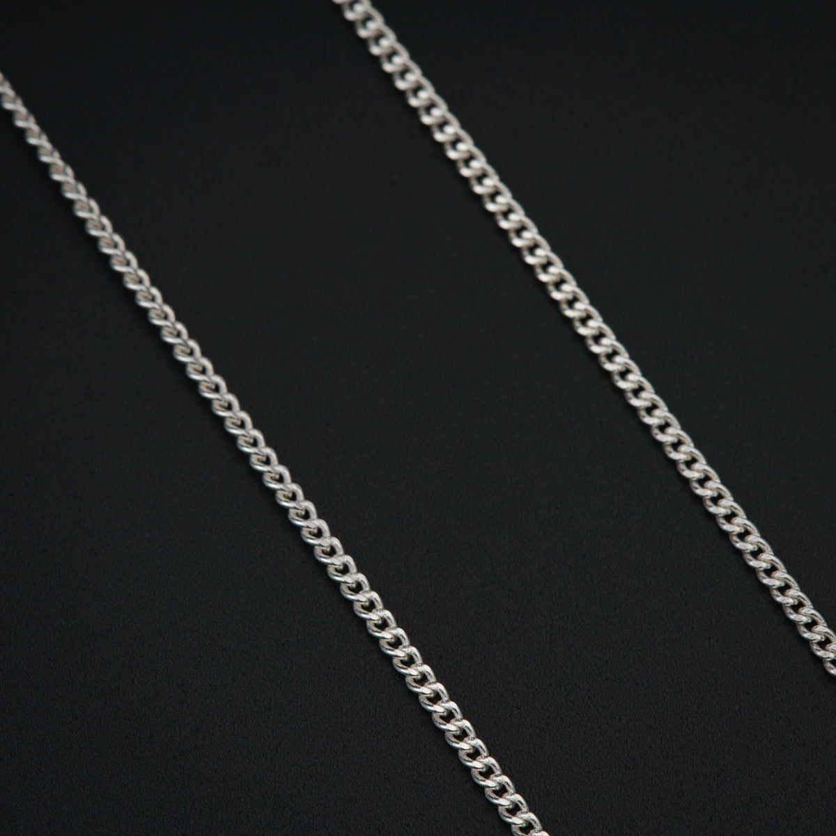 a silver chain on a black background