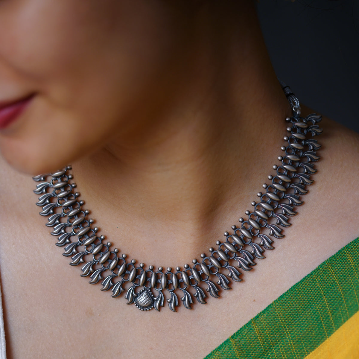 a close up of a woman wearing a necklace