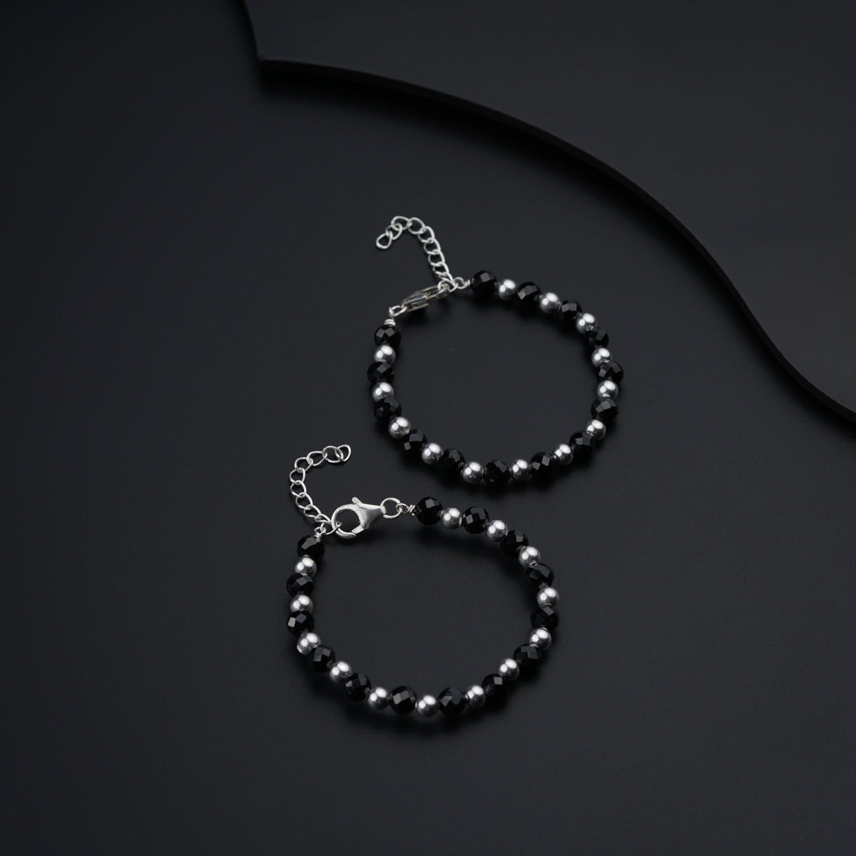 a couple of bracelets sitting on top of a table