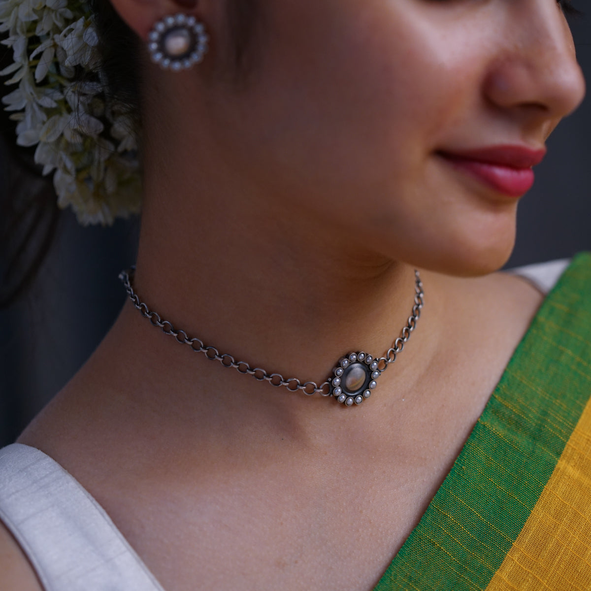 a close up of a woman wearing a necklace