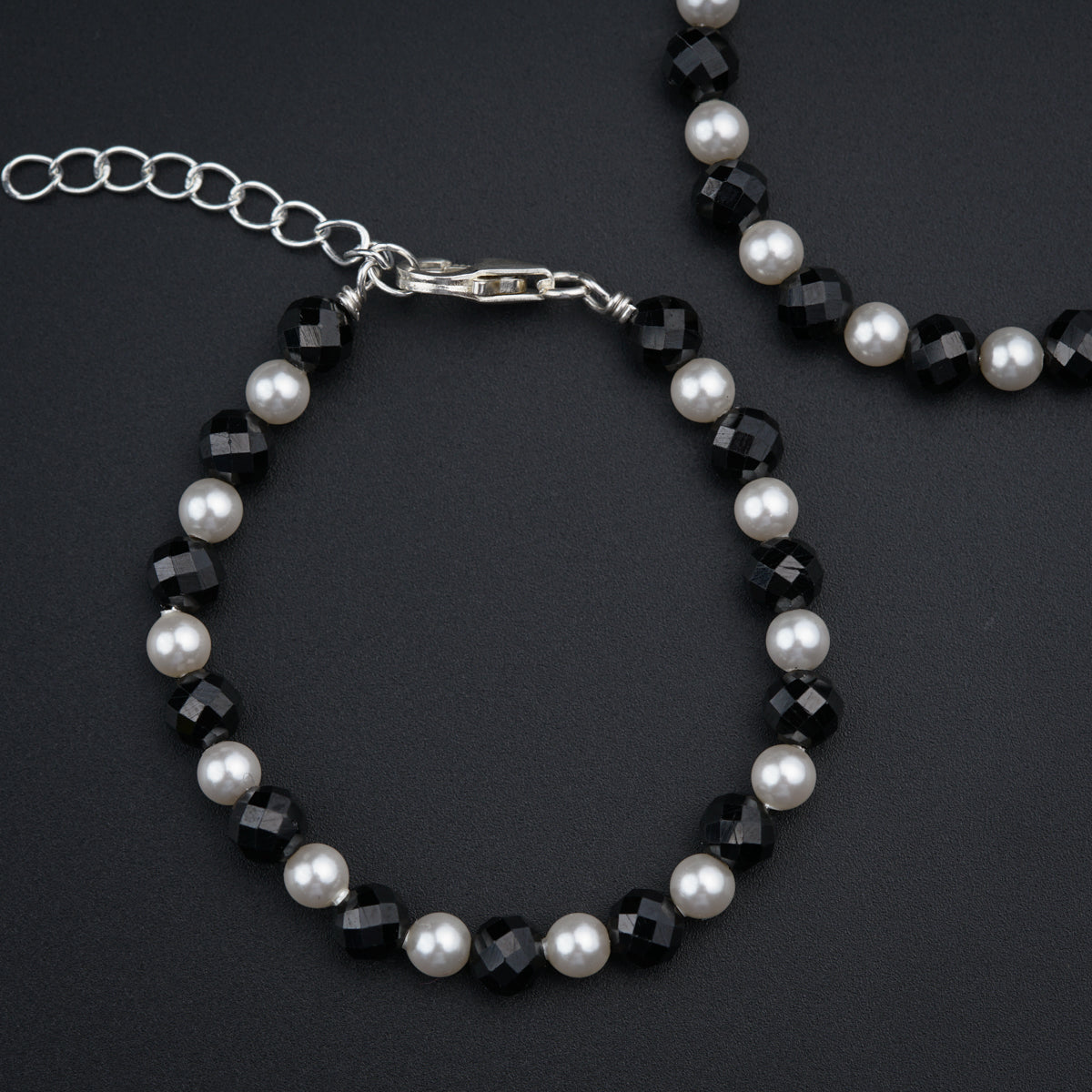 a close up of a bracelet and a necklace on a table