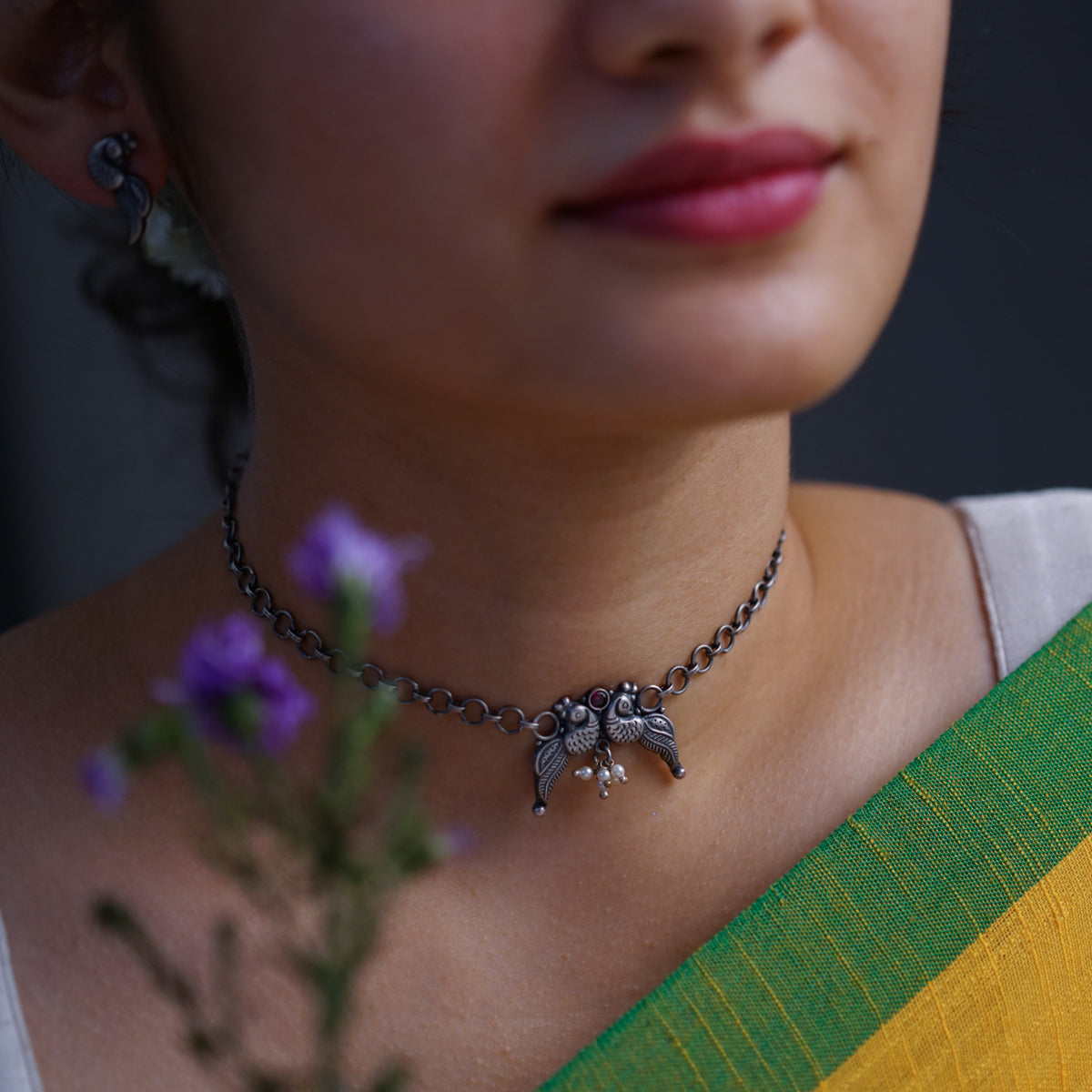 a close up of a woman wearing a necklace