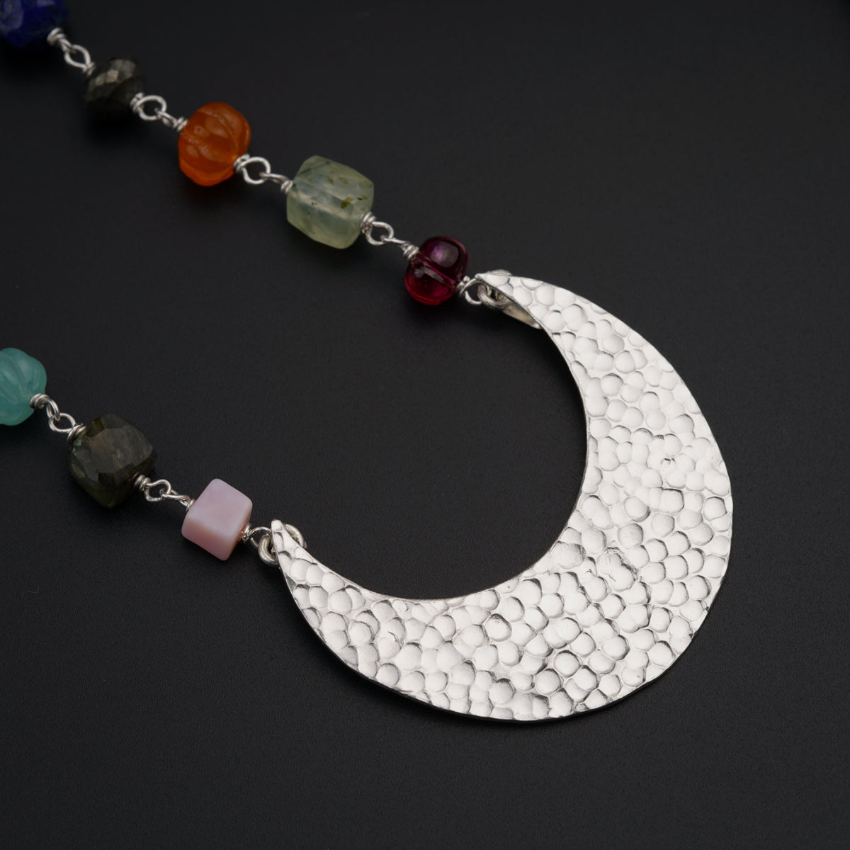 a necklace with a crescent and beads on it