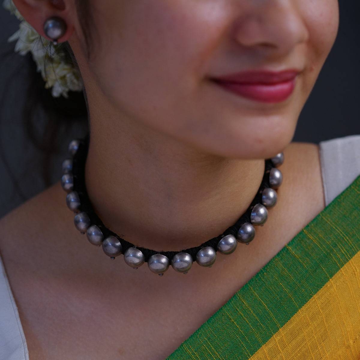 a close up of a woman wearing a necklace