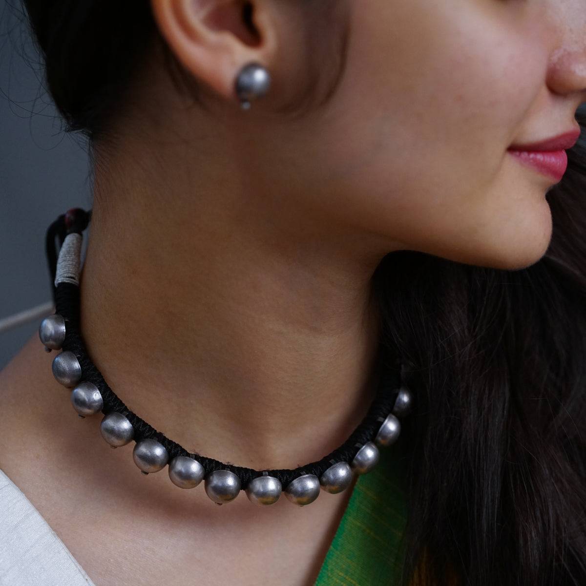 a close up of a woman wearing a necklace