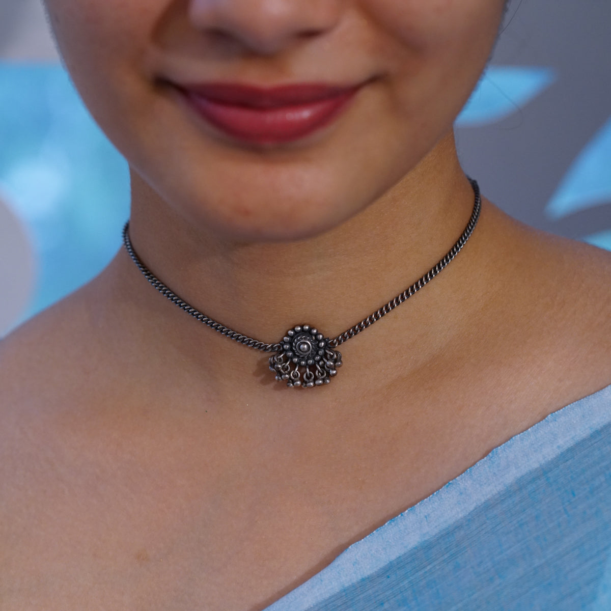 a close up of a woman wearing a necklace