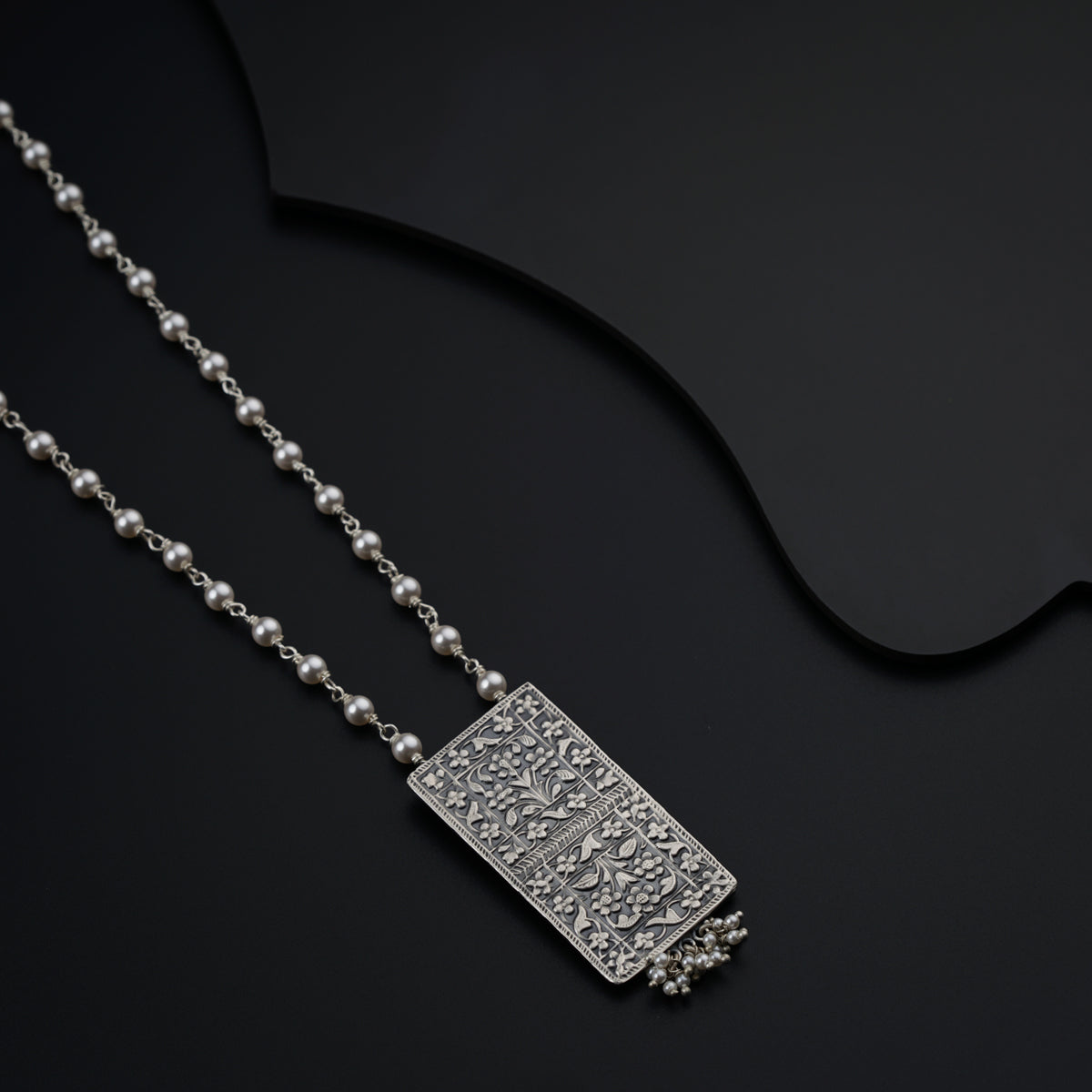 a couple of necklaces sitting on top of a table