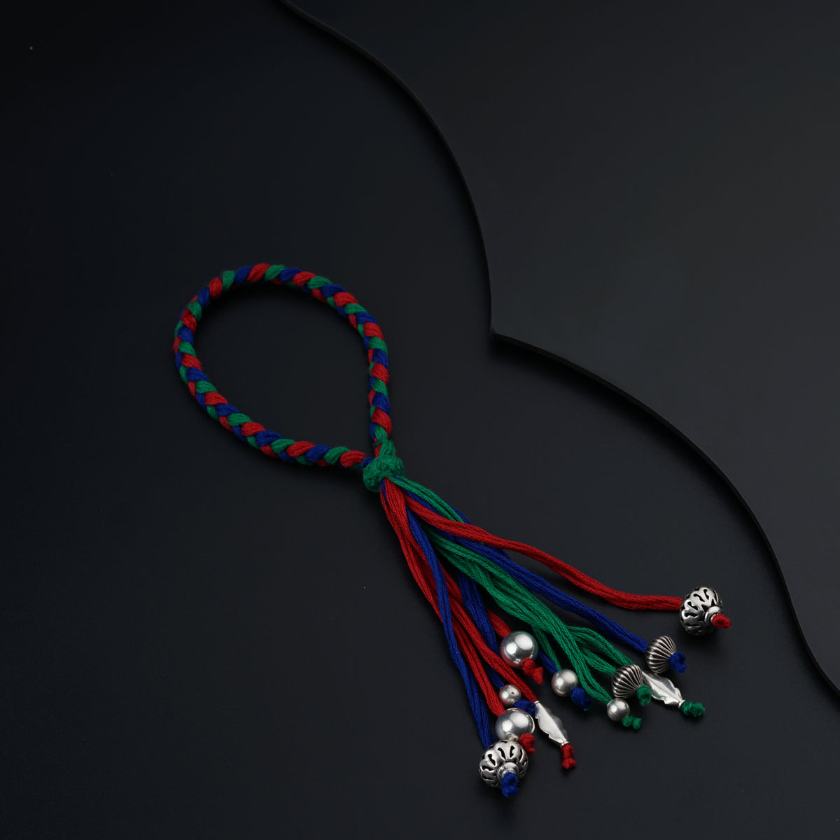a string with bells on a black surface