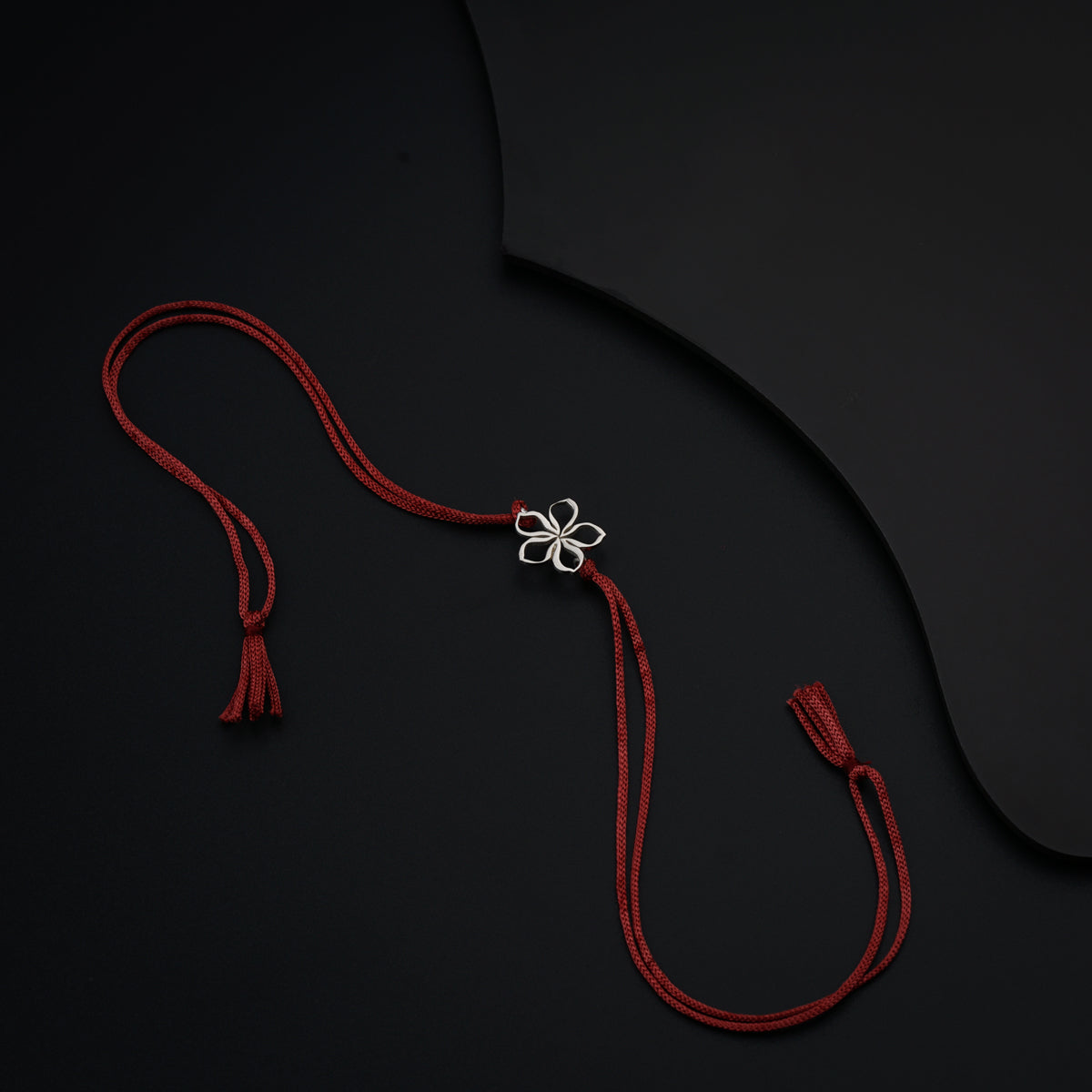 a red cord with a flower on it