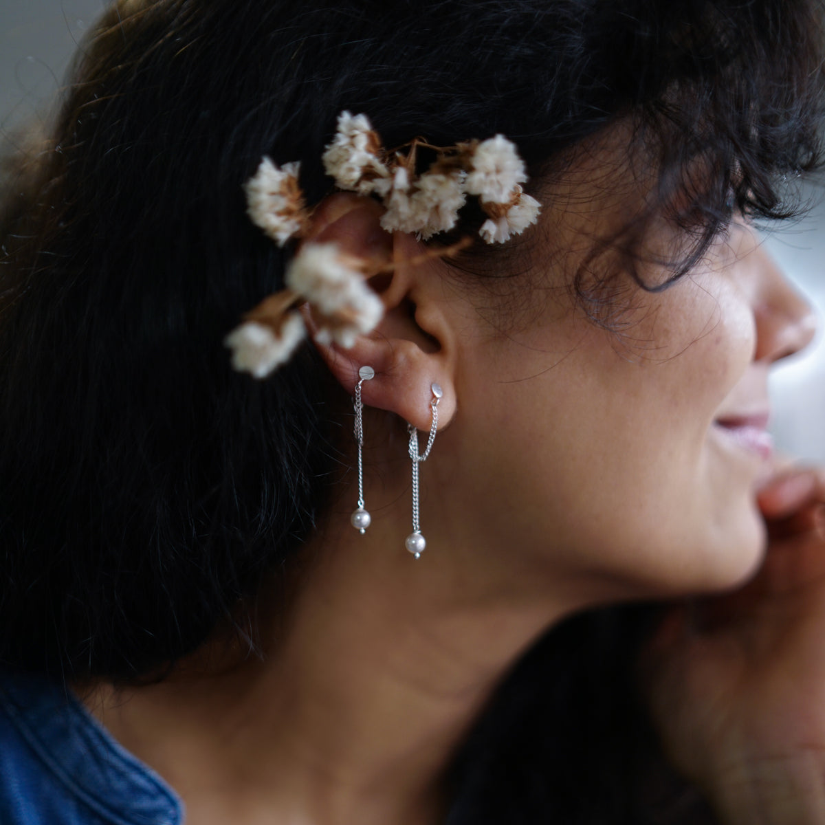 a woman with a flower in her ear