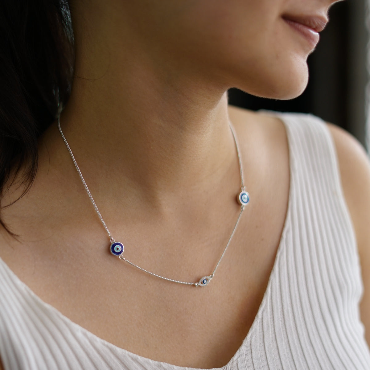 evil eye pendant detailing on silver necklace