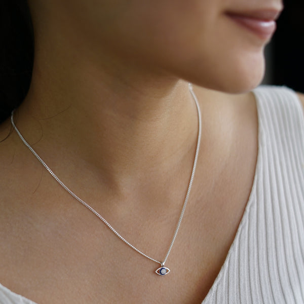 a close up of a woman wearing a necklace