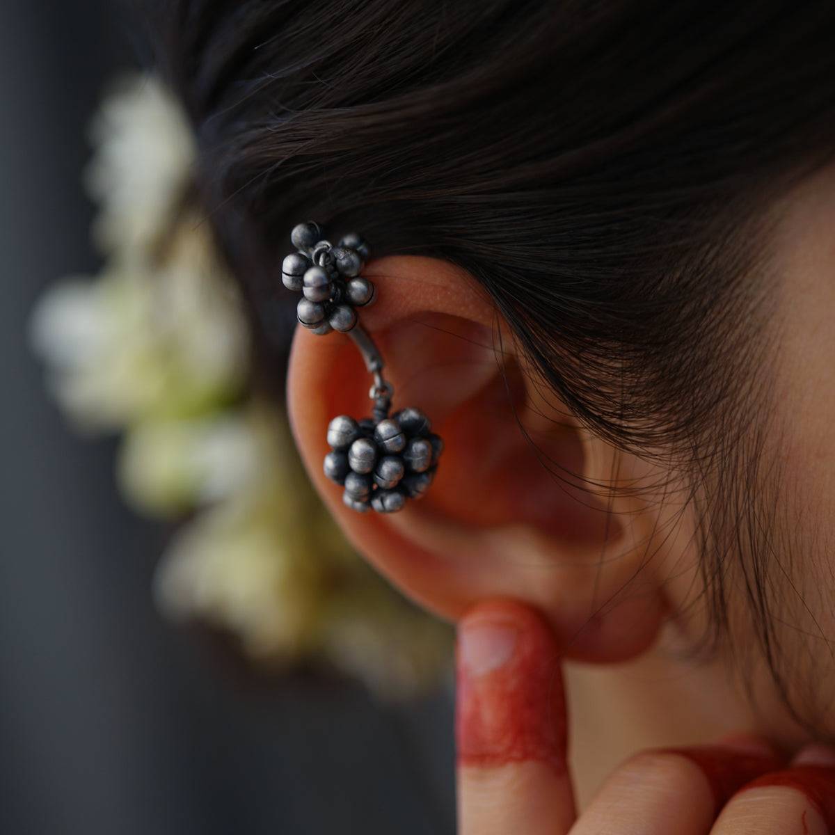 a close up of a person wearing a pair of ear piercings