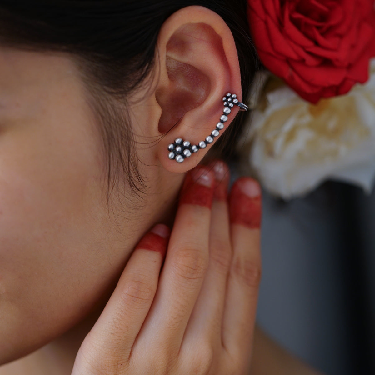 a woman wearing a pair of ear piercings
