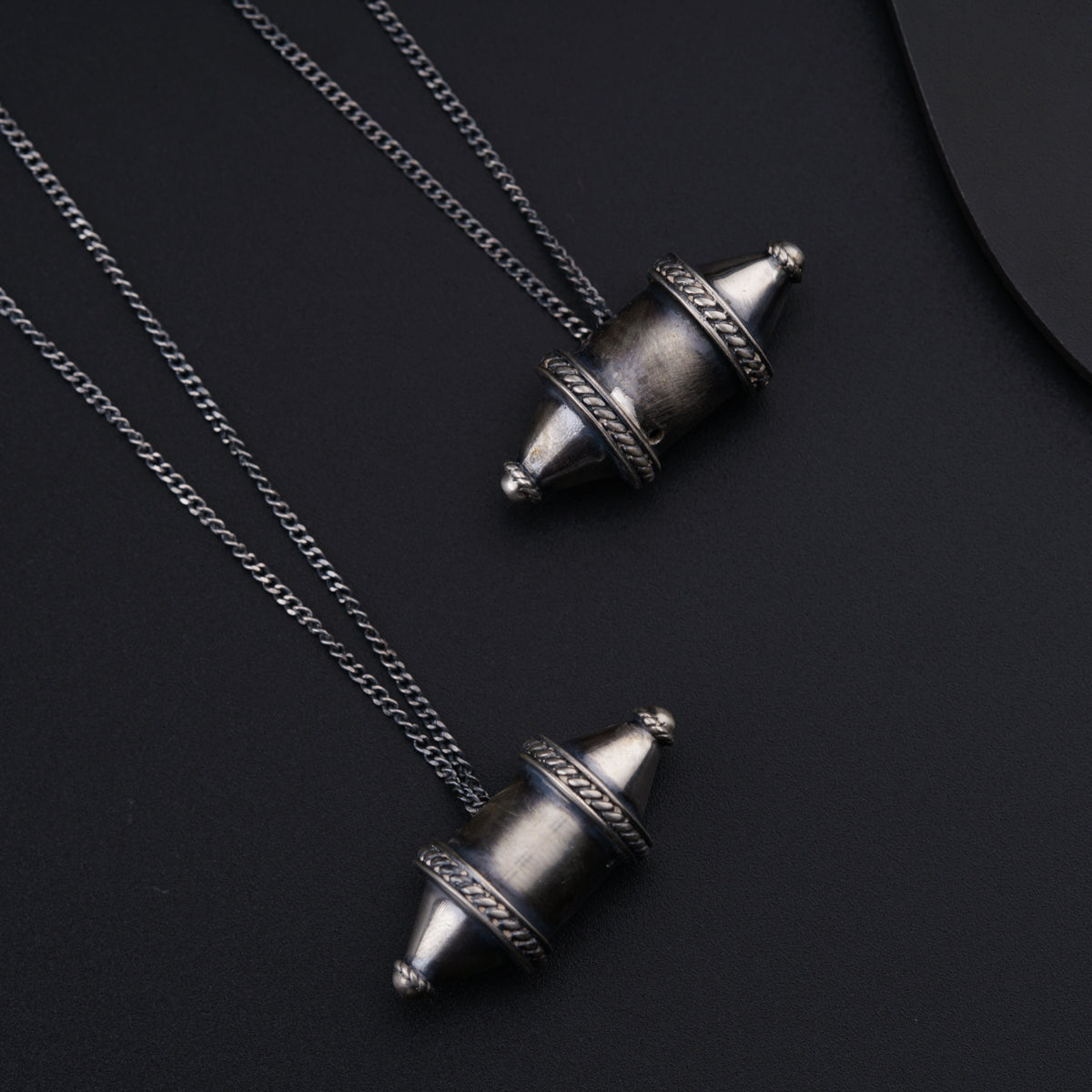 a couple of necklaces sitting on top of a table