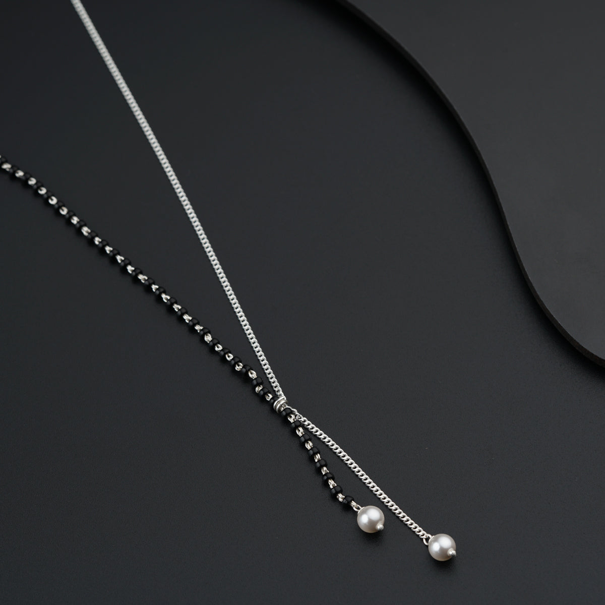 a couple of necklaces sitting on top of a table