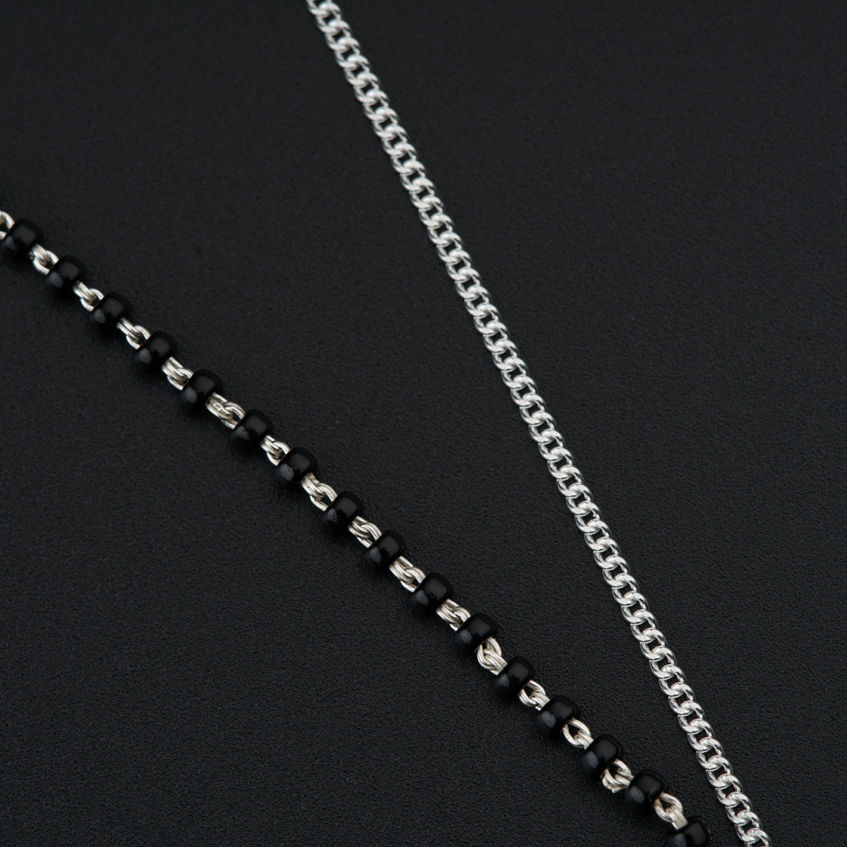 a close up of a chain on a black surface