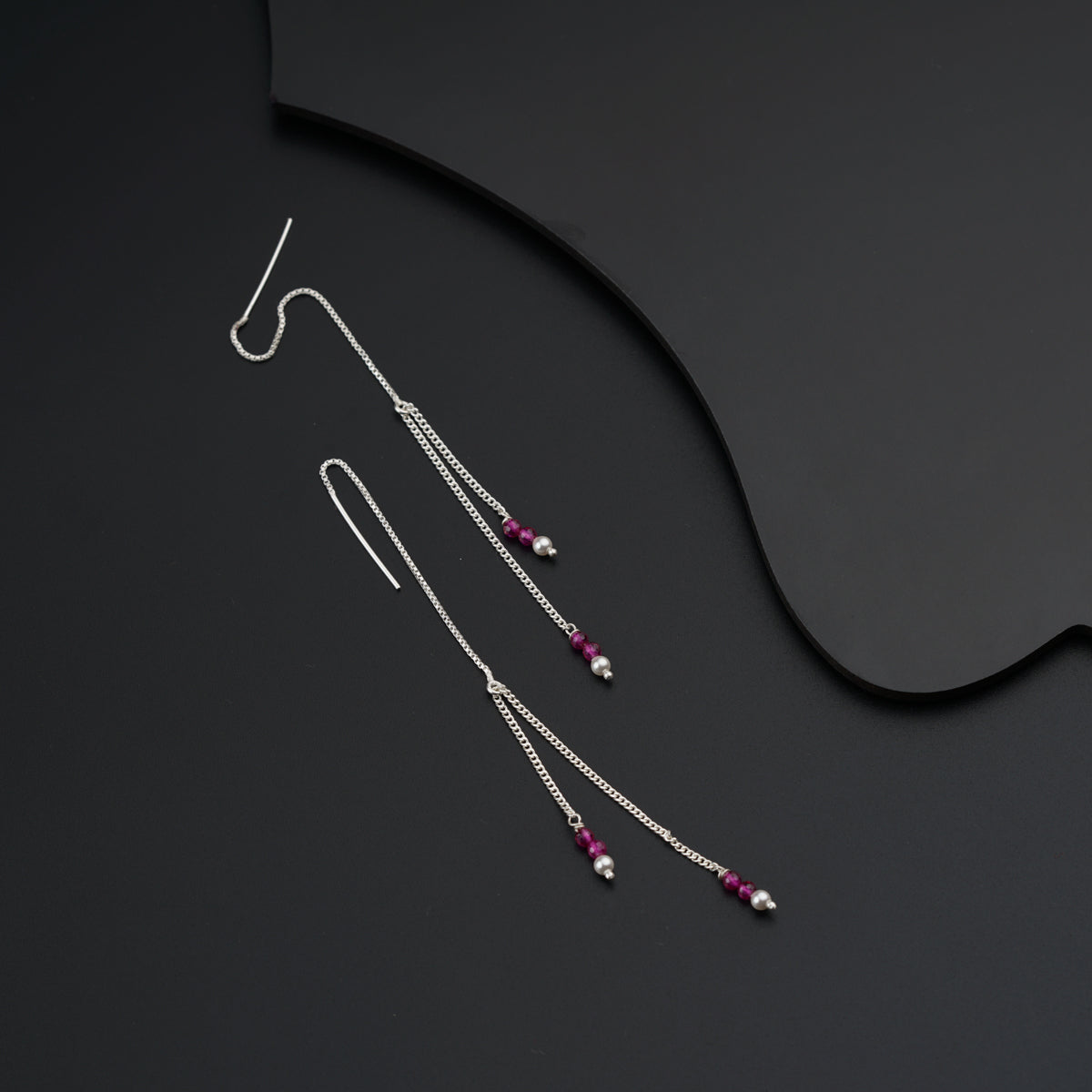 a pair of silver and pink beaded earrings