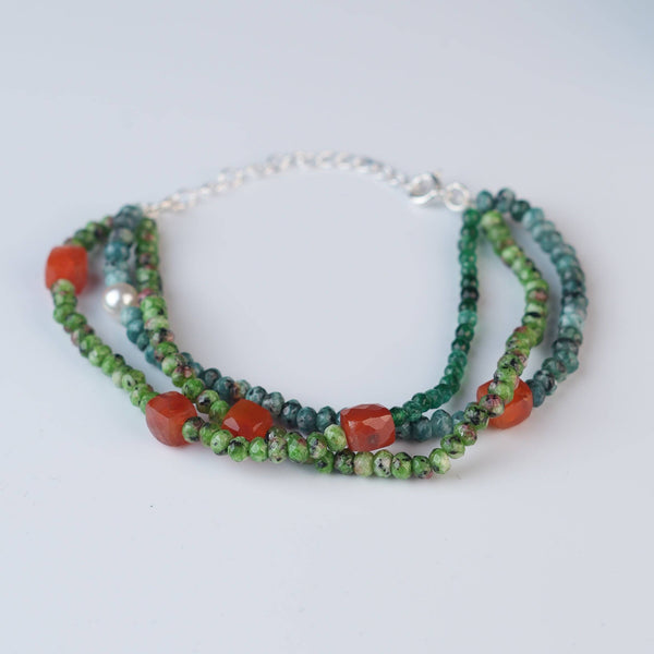 Angled view of Carnelian, Green Onyx, Green Jade & Blue Jade Silver Bracelet in 92.5 sterling silver with multicolour gemstone detailing