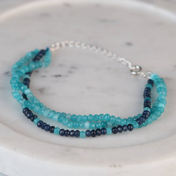 Angled view of Dark & Light Blue Jade Silver Bracelet in 92.5 sterling silver with contrasting blue jade gemstone detailing