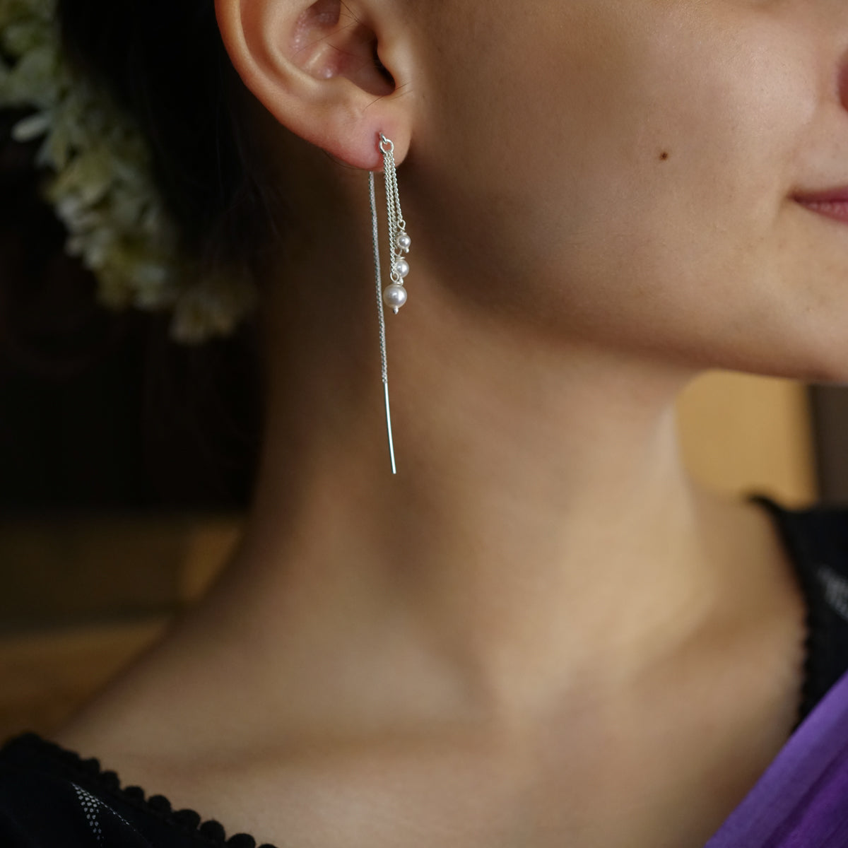 a close up of a person wearing a pair of earrings