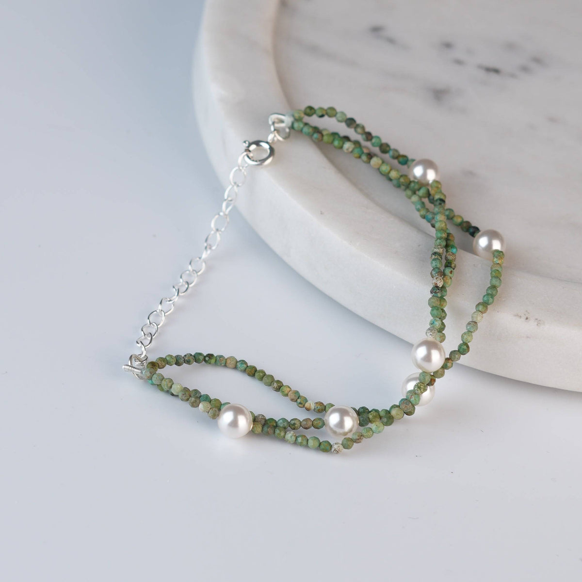 Angled view of Micro Firoza & Pearl Silver Bracelet in 92.5 sterling silver with firoza and pearl detailing
