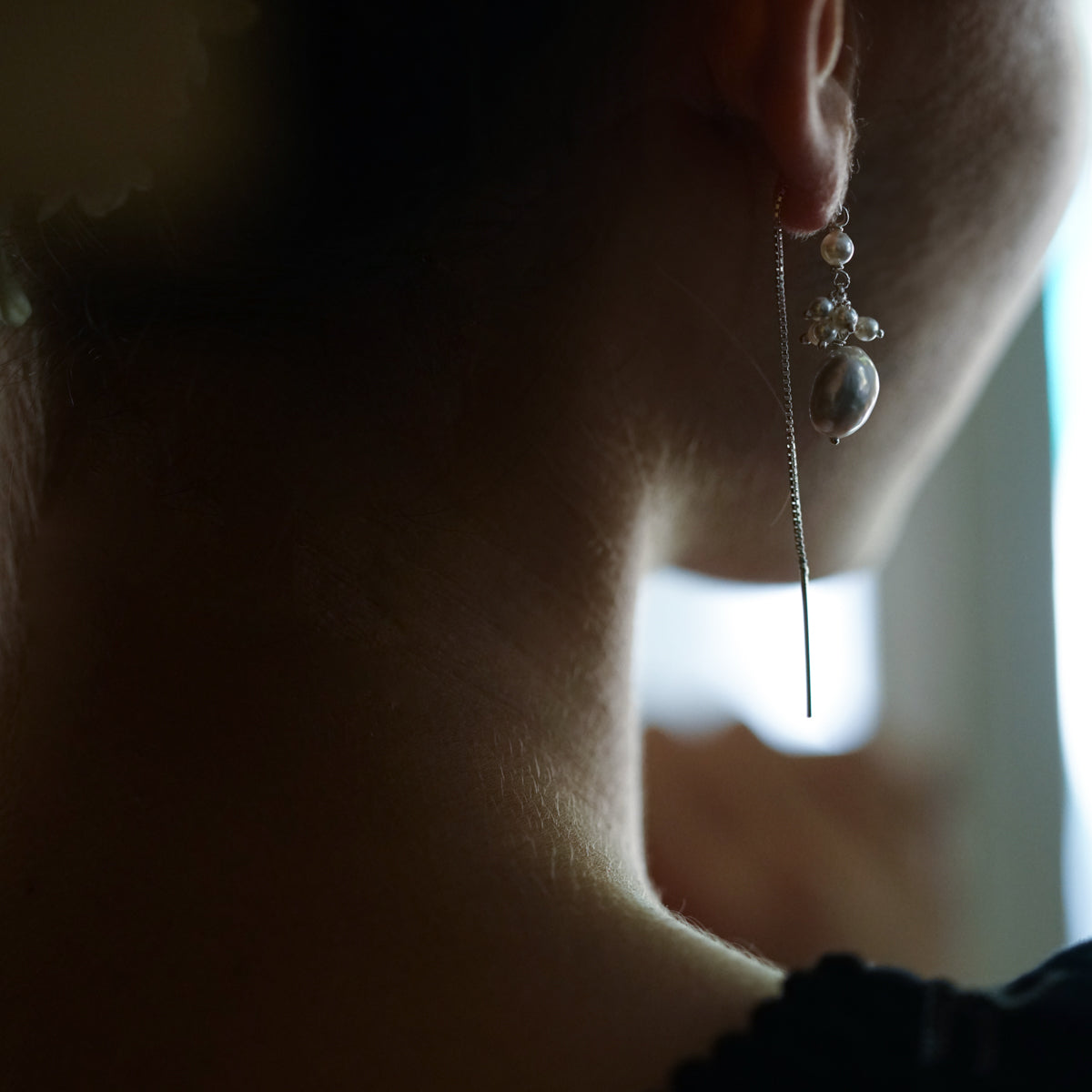 a close up of a person wearing a pair of earrings