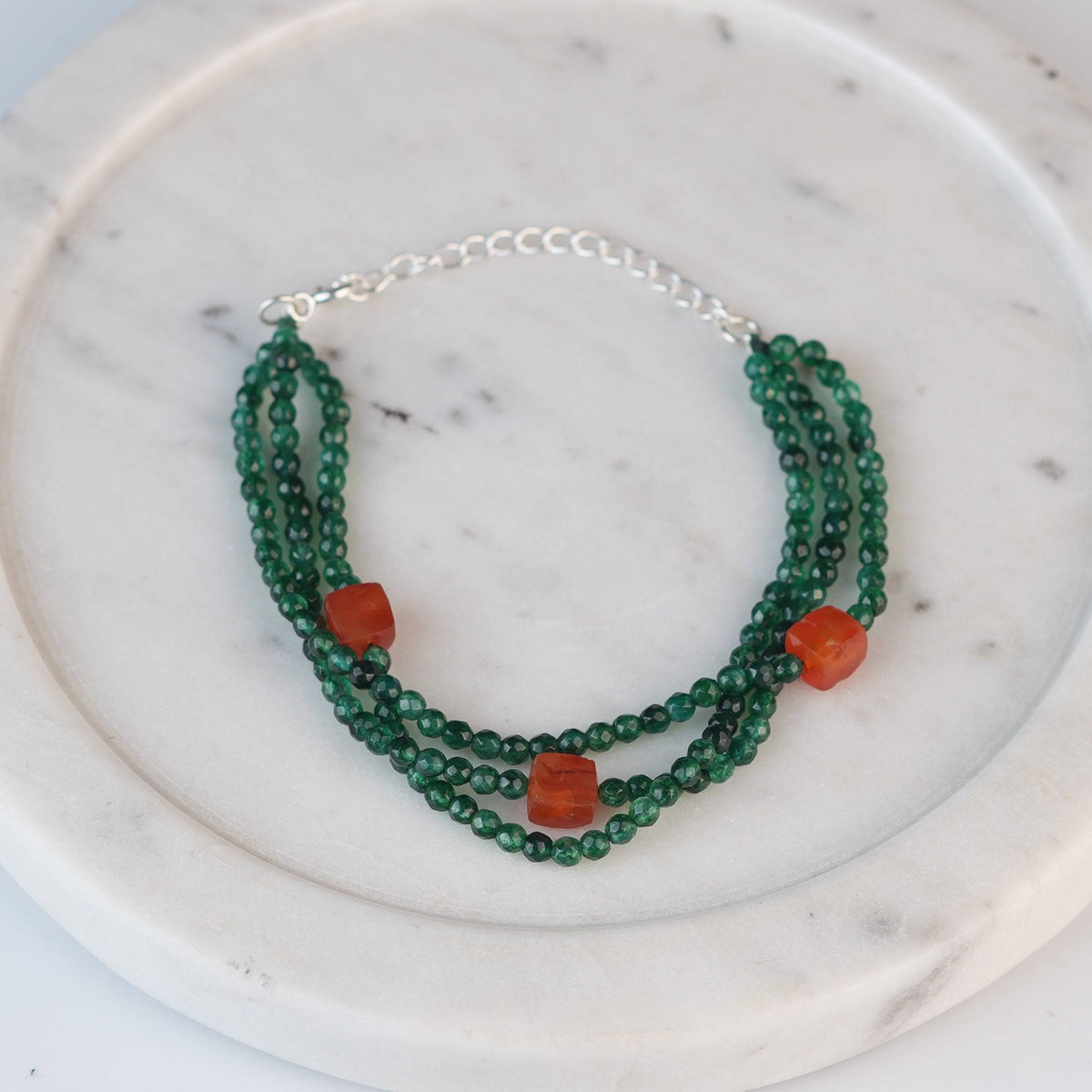 Angled view of Green Onyx & Carnelian Silver Bracelet in 92.5 sterling silver with green onyx and carnelian gemstone detailing
