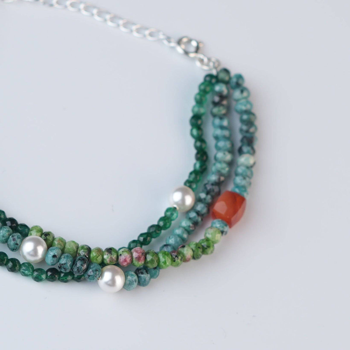 Close-up of Green Onyx, Pearl, Carnelian Cube, Green & Blue Jade Silver Bracelet showcasing natural gemstones, pearls, and intricate handmade silver craftsmanship