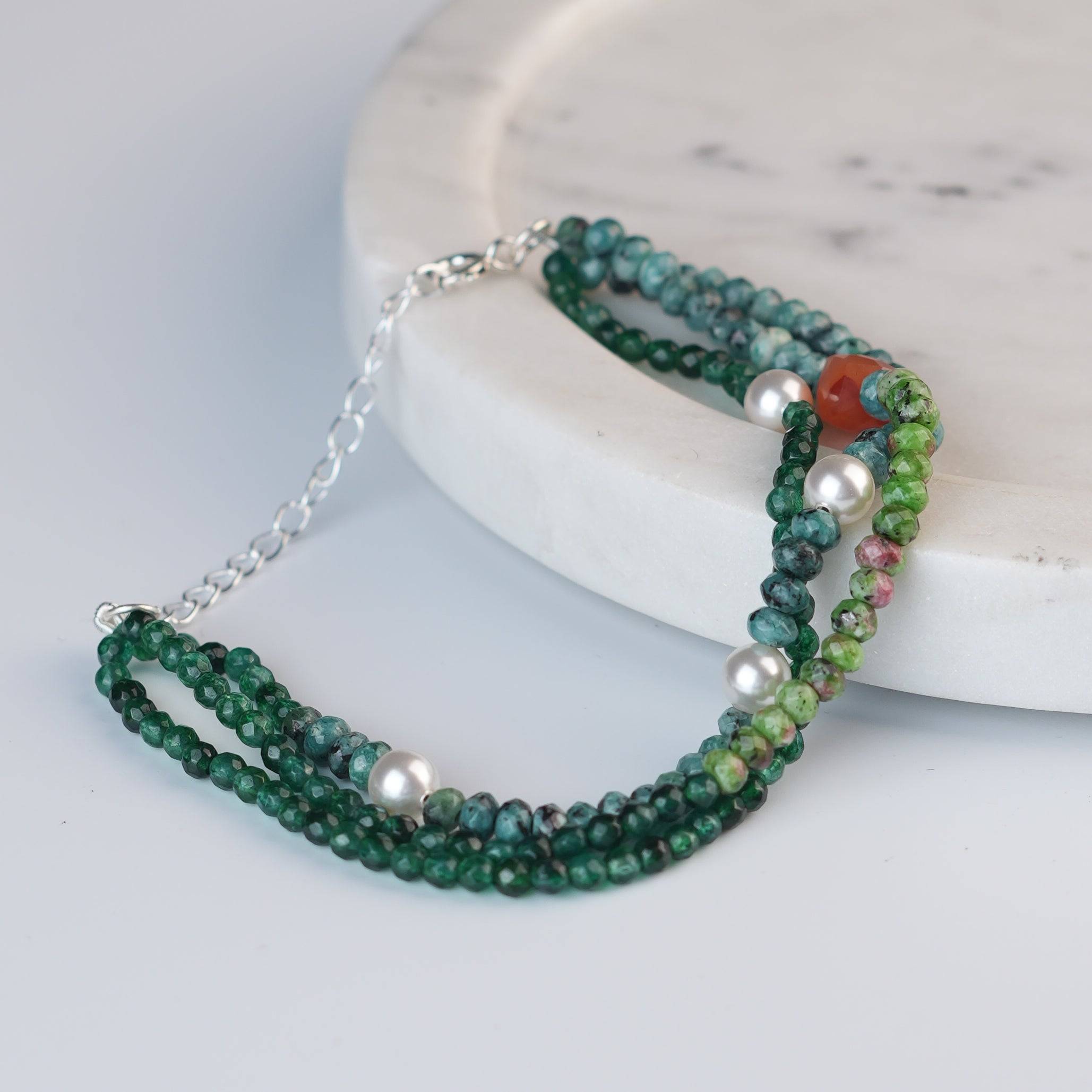 Angled view of Green Onyx, Pearl, Carnelian Cube, Green & Blue Jade Silver Bracelet in 92.5 sterling silver with multicolour gemstone detailing