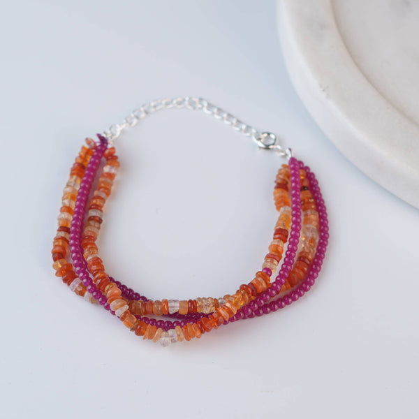 Angled view of Ruby & Carnelian Silver Bracelet in 92.5 sterling silver with ruby and carnelian gemstone detailing