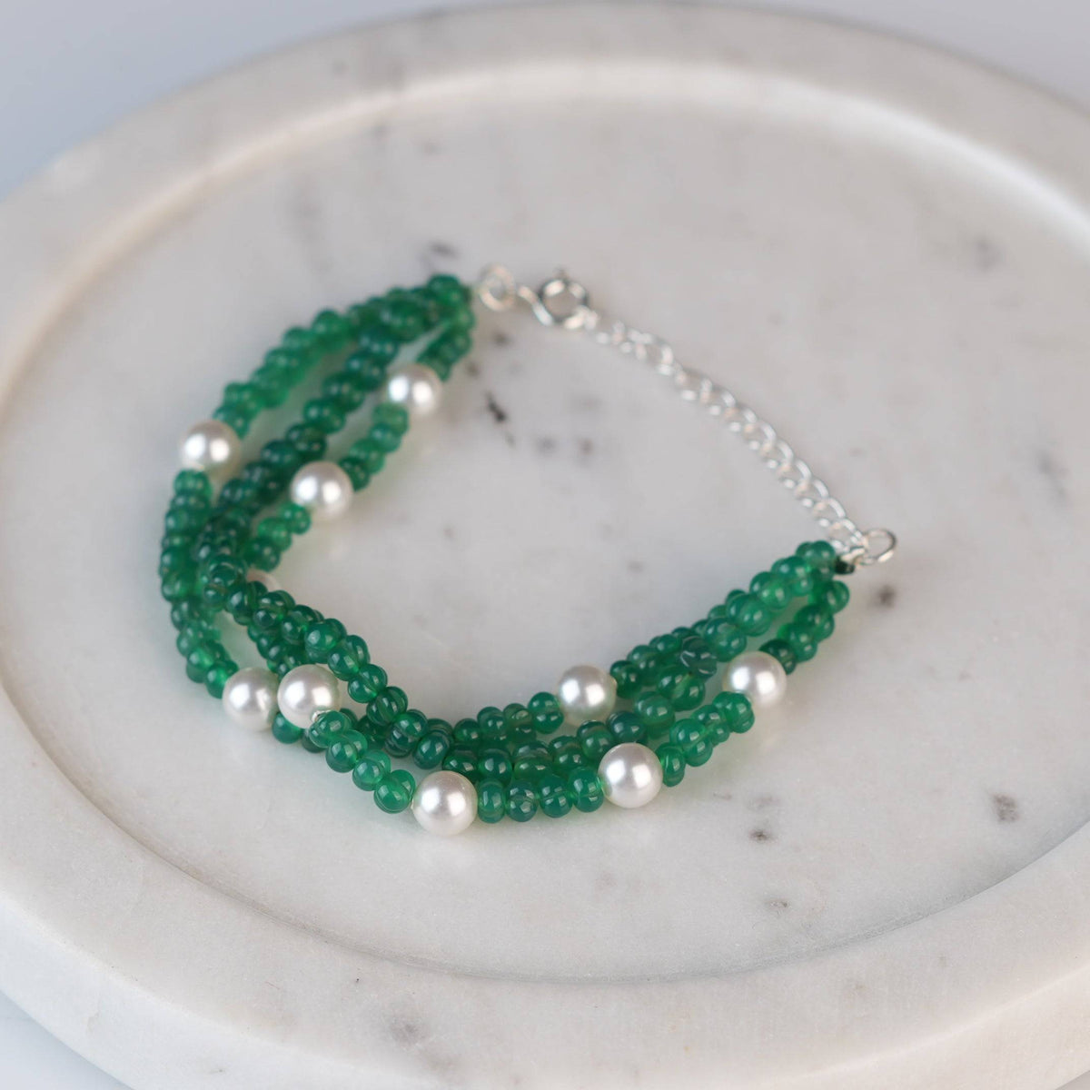 Angled view of Green Onyx & Pearl Silver Bracelet in 92.5 sterling silver with green onyx and pearl detailing