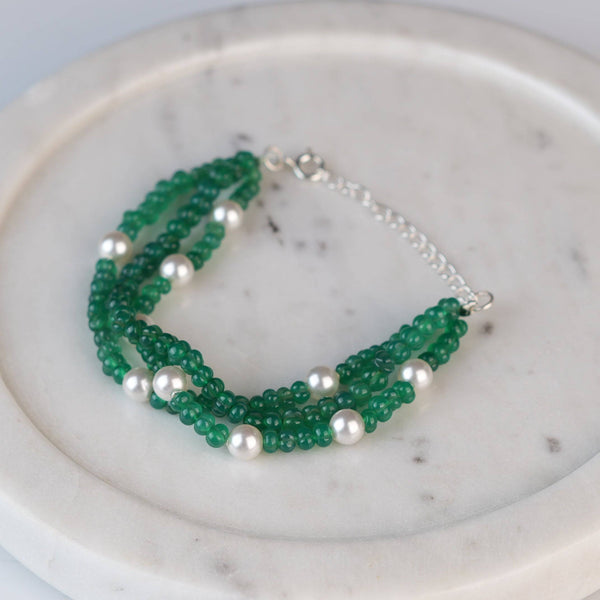 Angled view of Green Onyx & Pearl Silver Bracelet in 92.5 sterling silver with green onyx and pearl detailing