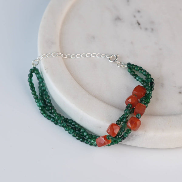 Angled view of Green Onyx & Carnelian Silver Bracelet in 92.5 sterling silver with green onyx and carnelian gemstone detailing