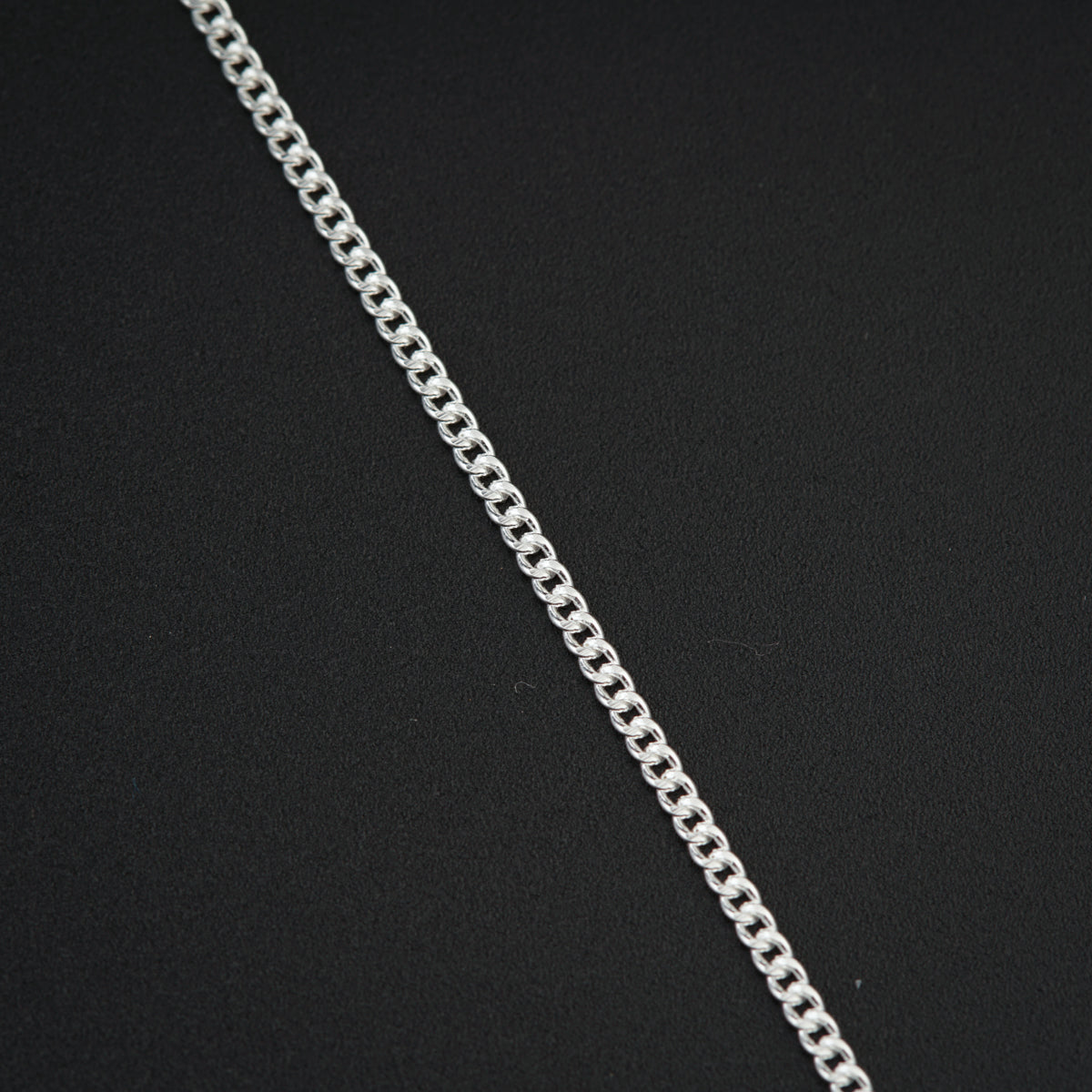 a silver chain on a black background