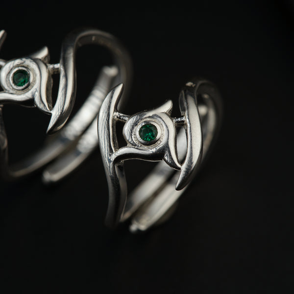 a close up of two rings on a black surface