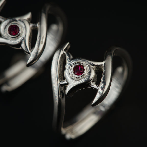 a close up of two rings on a black background