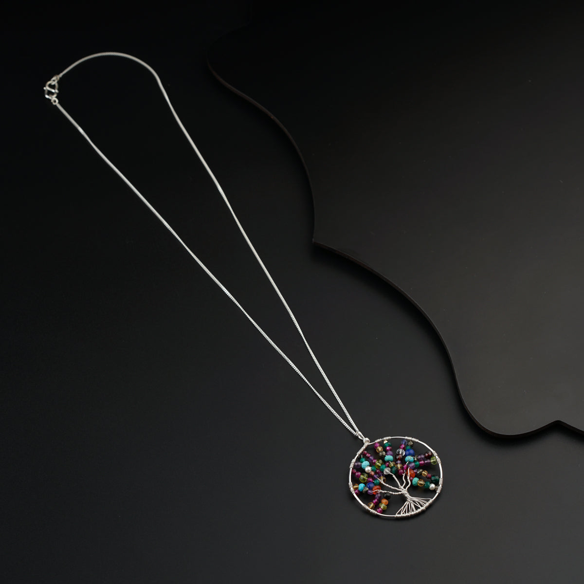 a necklace with a tree of life pendant