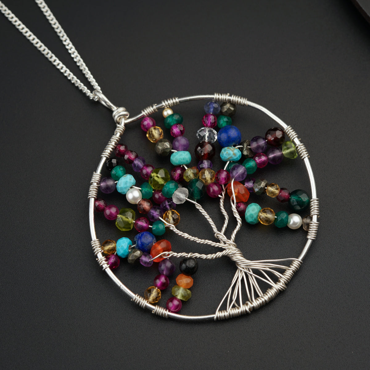 a tree of life pendant with multicolored beads
