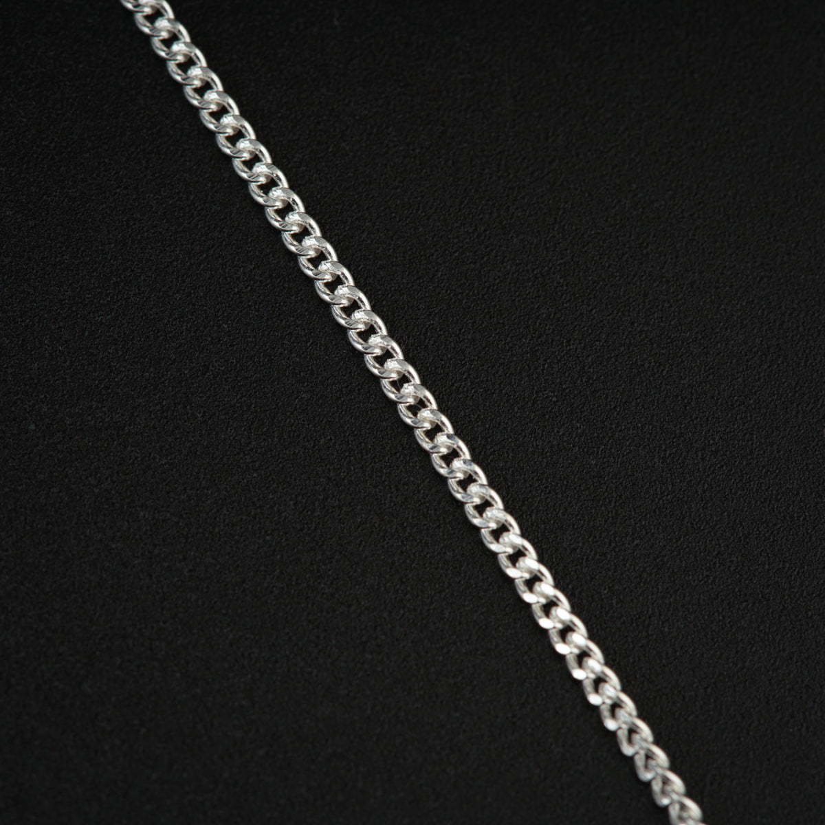 a silver chain on a black background