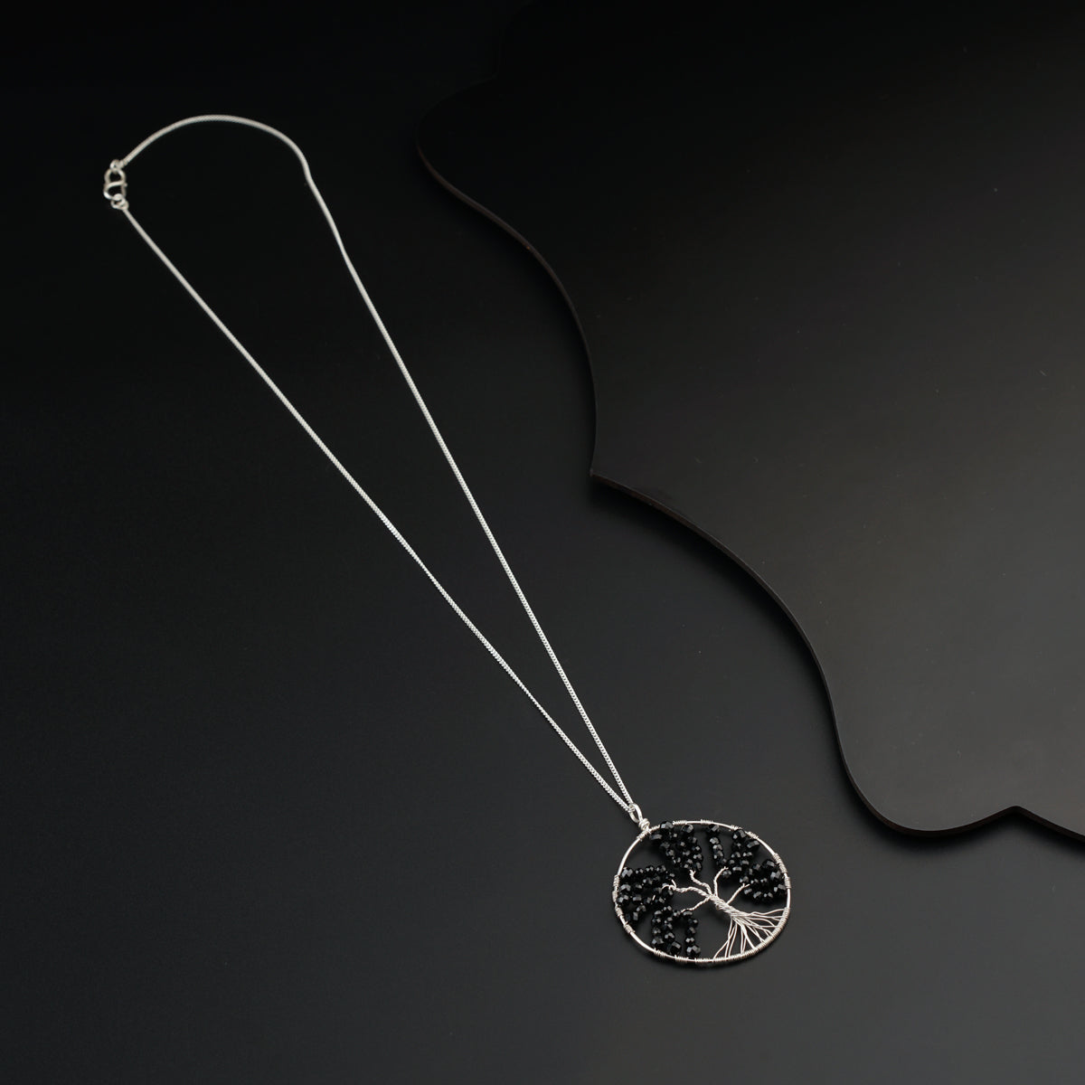 a necklace with a tree of life on it
