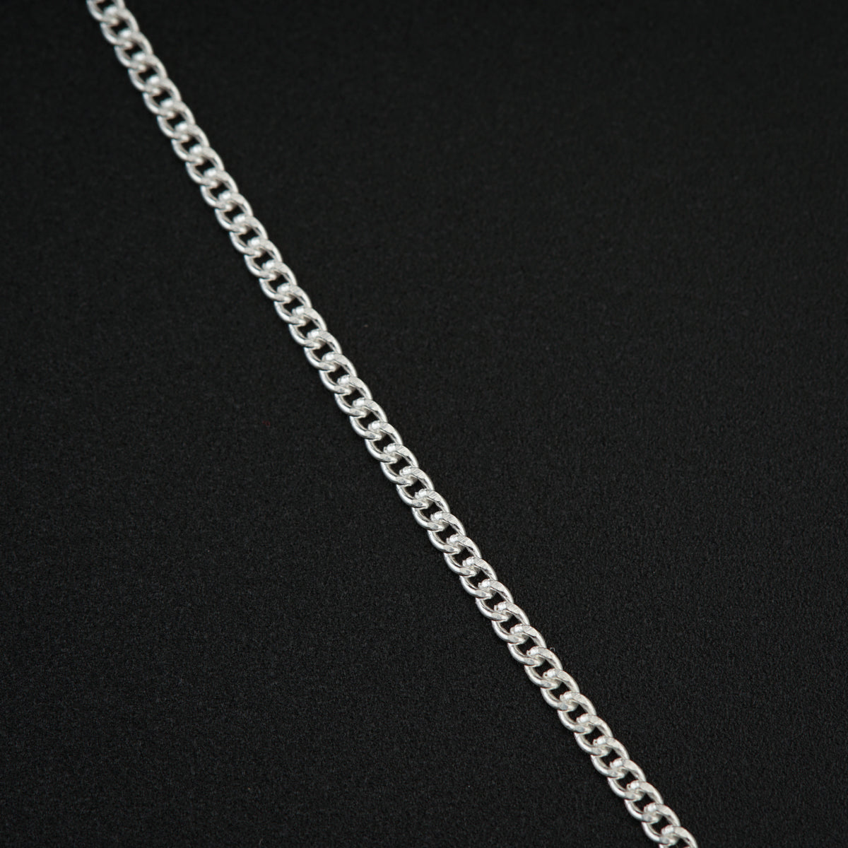 a silver chain on a black background