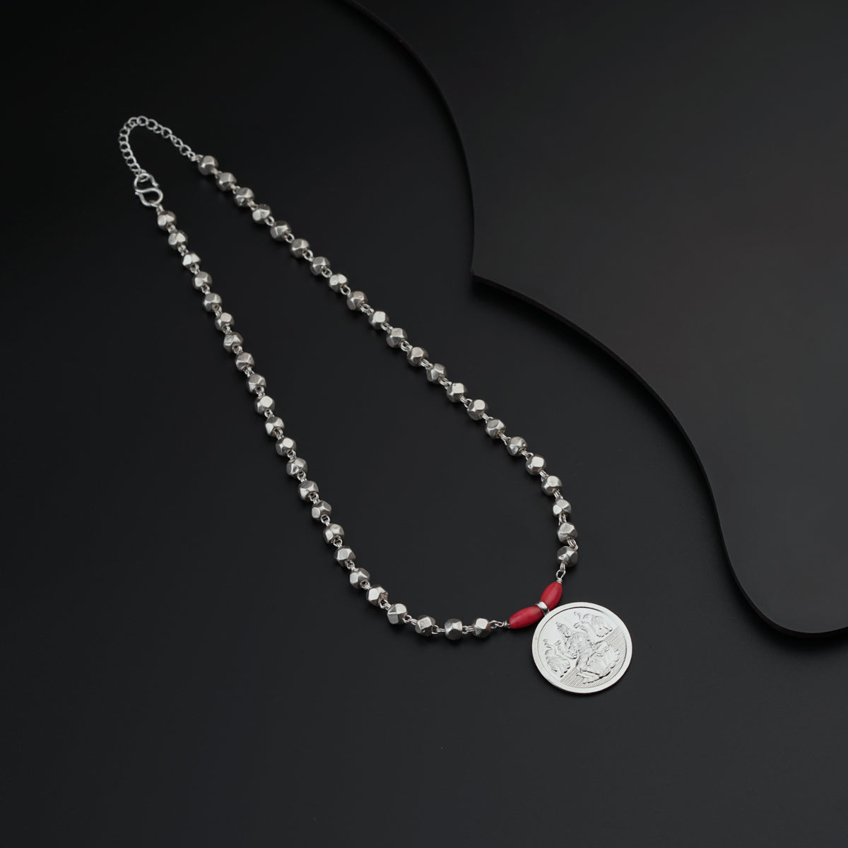 a silver chain with a coin on it